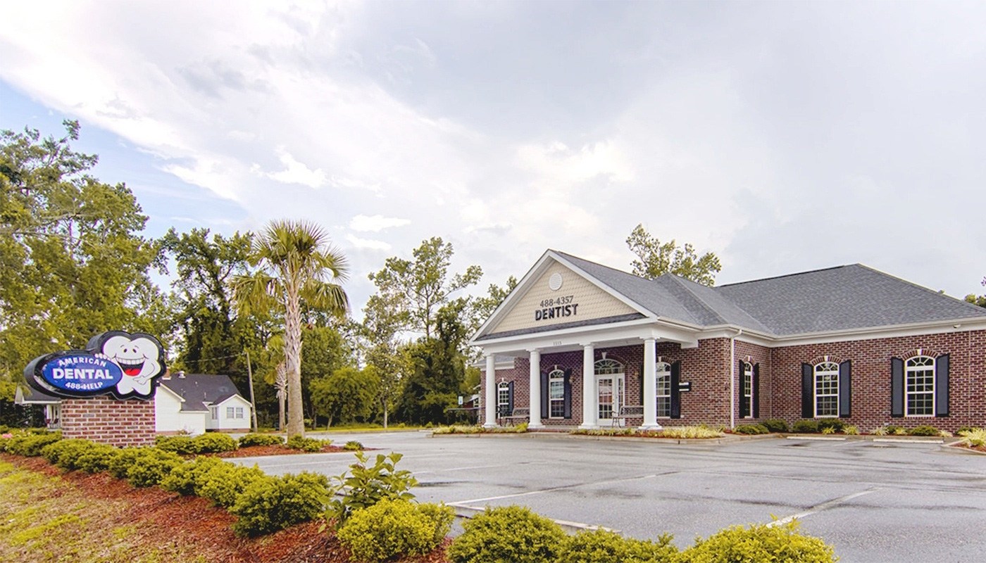 Outside view of American Dental Care office building in Conway