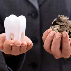 Hands holding tooth and coins