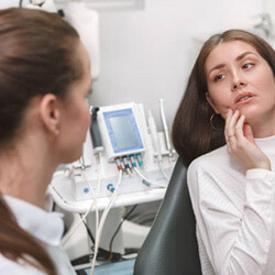 woman with a toothache at emergency dentist