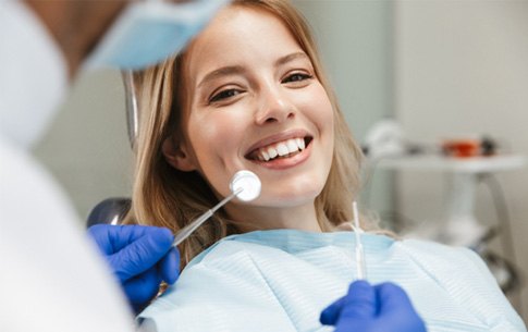 patient smiling while visiting dentist 