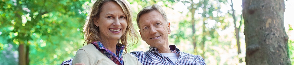 Older man and woman smiling outdoors