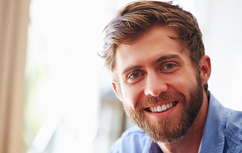 Close-up of a bearded man smiling