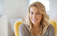 Woman sitting on yellow chair and smiling