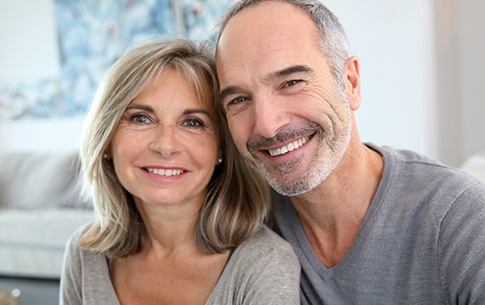 Older man and woman smiling together