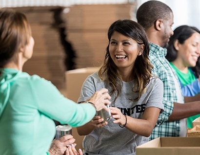 Group of smiling people at canned food drive