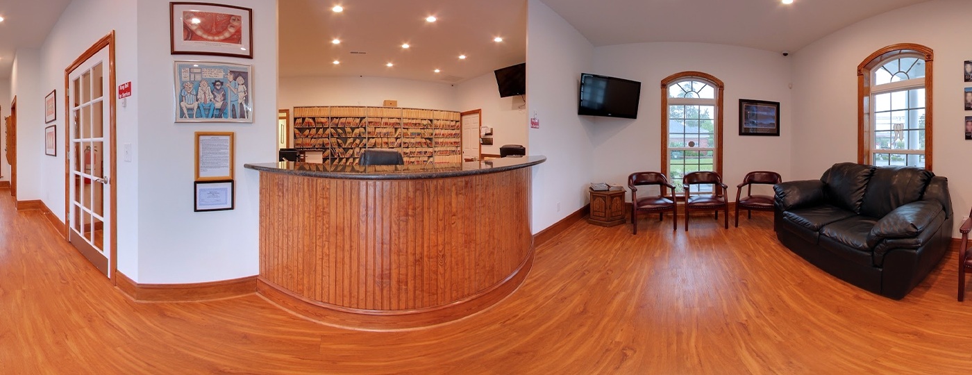 Panoramic view of dental office waiting room and reception desk