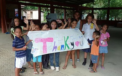 Kids holding up thank you sign