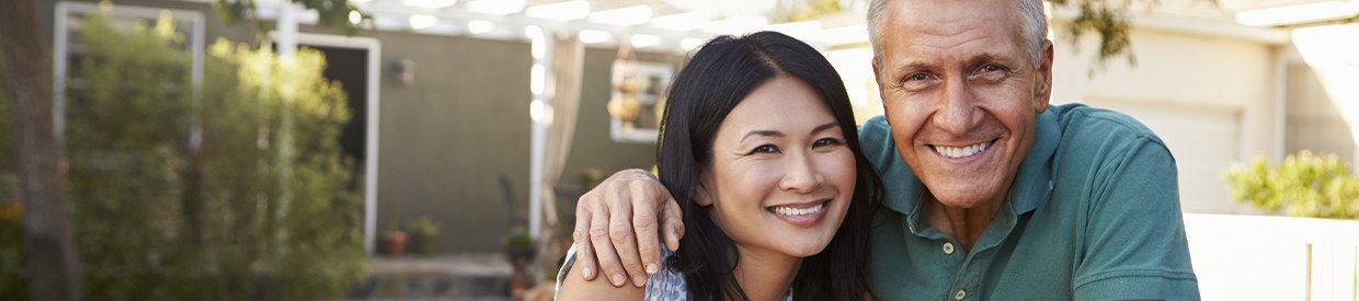 Smiling man and woman outdoors