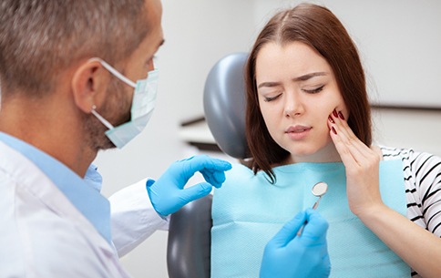 A dentist helping a patient with a toothache