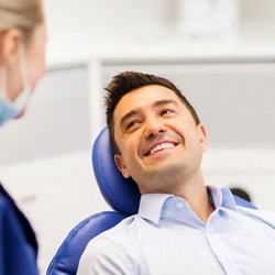 patient smiling during a checkup to prevent dental emergencies in Conway