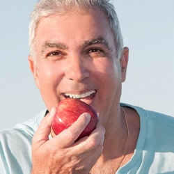 person eating a nutritious diet to prevent dental emergencies in Conway