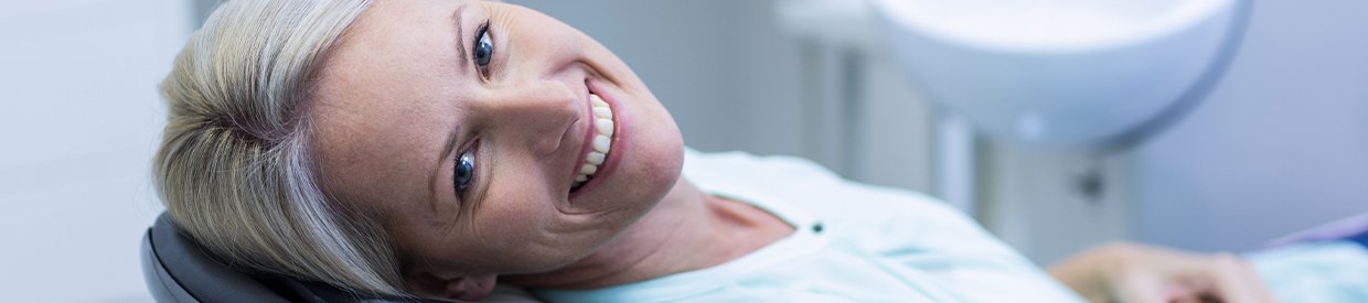 Older woman in dental chair smiling