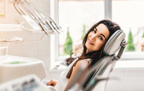 Female dental patient leaning back in chair