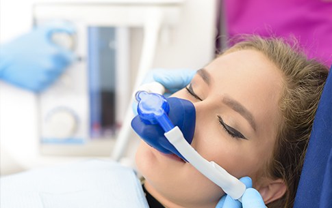 Woman with nitrous oxide nose mask