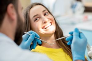 Woman smiling during her dental checkup.