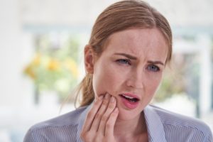 Woman suffering from tooth pain
