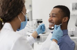 young man asking his dentist about root canal myths 