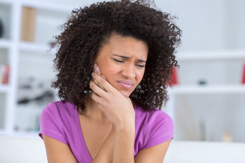 young woman with jaw pain on one side