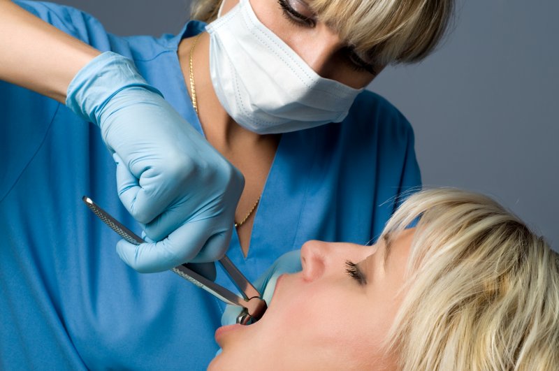 dentist performing tooth extraction in Conway on female patient
