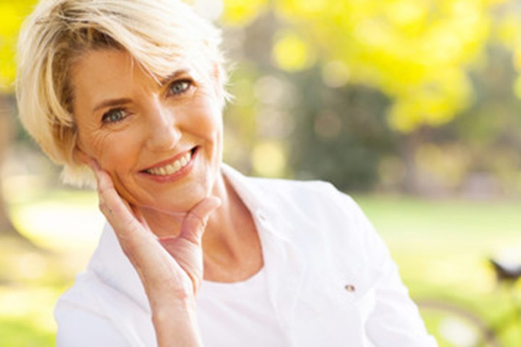 Woman smiling after receiving cosmetic dentistry