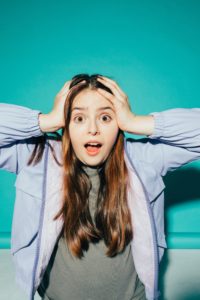 Panicked woman with her hands on her head