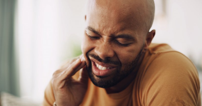 young man dealing with wisdom teeth pain