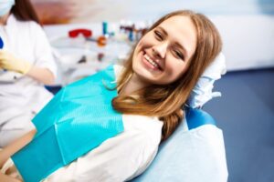 Woman smiling after her tooth extraction